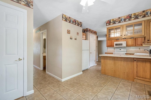 127 Hilltop Trl, Eureka, MO 63025 - kitchen with light countertops, light tile patterned floors, white appliances, and glass insert cabinets