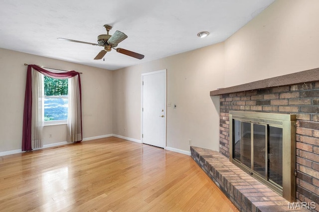 127 Hilltop Trl, Eureka, MO 63025 - unfurnished living room with light wood-style flooring, ceiling fan, and a brick fireplace