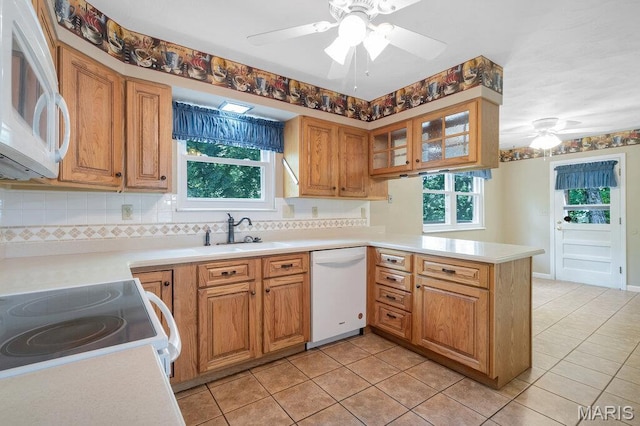 127 Hilltop Trl, Eureka, MO 63025 - kitchen featuring a ceiling fan, a peninsula, white appliances, and light tile patterned floors