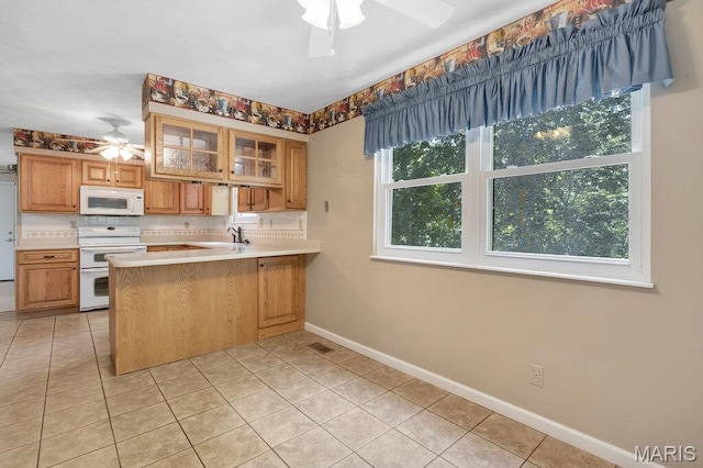 127 Hilltop Trl, Eureka, MO 63025 - kitchen with ceiling fan, white appliances, light tile patterned floors, and glass insert cabinets