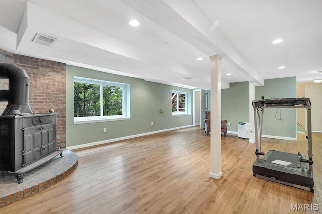 127 Hilltop Trl, Eureka, MO 63025 - workout room with a wood stove, light wood finished floors, and recessed lighting