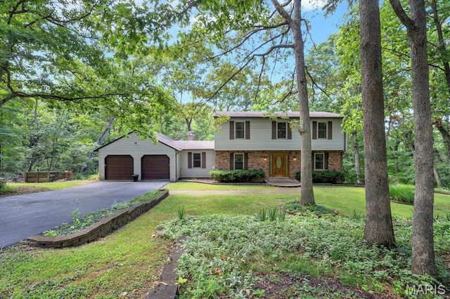 127 Hilltop Trl, Eureka, MO 63025 - colonial inspired home featuring brick siding, driveway, an attached garage, a front lawn, and a chimney