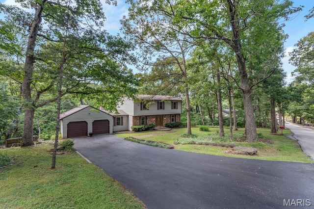 127 Hilltop Trl, Eureka, MO 63025 - colonial house with driveway, an attached garage, a front yard, and brick siding