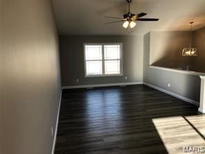 1158 Marathon Dr, Foristell, MO 63348 - unfurnished living room with ceiling fan, a chandelier, and wood finished floors