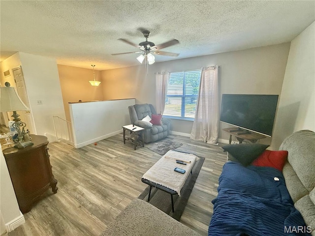 2284 Sunnyridge Dr, Arnold, MO 63010 - living area with wood finished floors, a textured ceiling, and ceiling fan