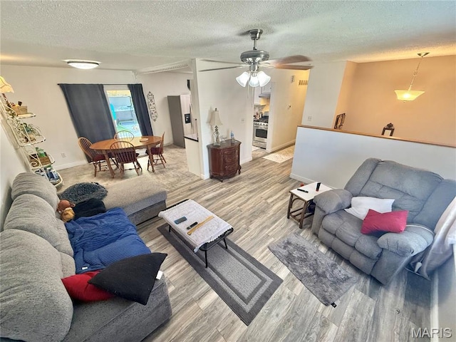 2284 Sunnyridge Dr, Arnold, MO 63010 - living area with light wood-style flooring, a textured ceiling, and a ceiling fan