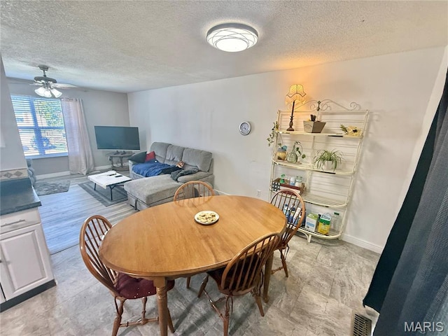 2284 Sunnyridge Dr, Arnold, MO 63010 - dining room with a textured ceiling and ceiling fan