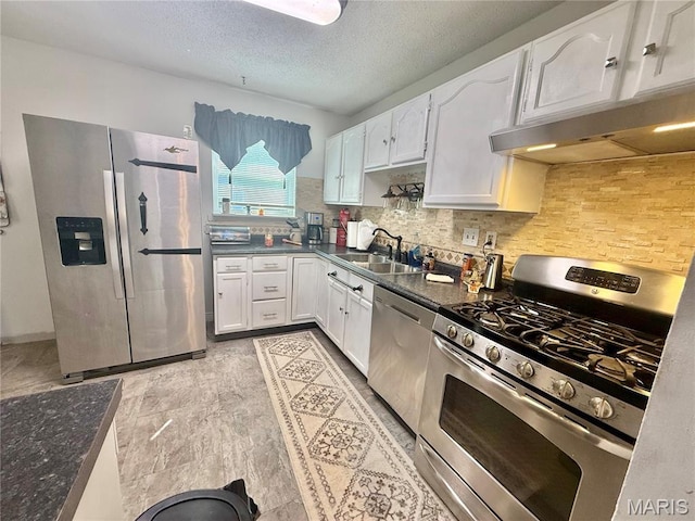 2284 Sunnyridge Dr, Arnold, MO 63010 - kitchen with stainless steel appliances, dark countertops, white cabinetry, tasteful backsplash, and a textured ceiling