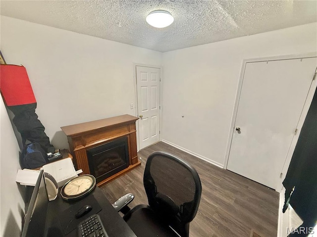 2284 Sunnyridge Dr, Arnold, MO 63010 - office space featuring wood finished floors, a glass covered fireplace, and a textured ceiling