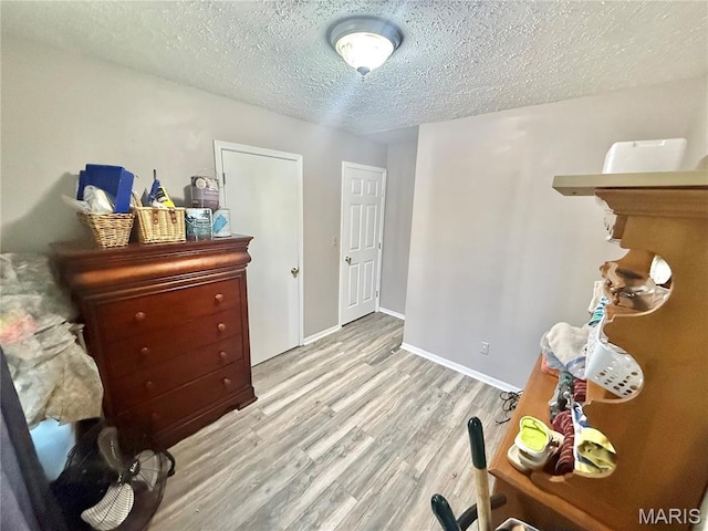 2284 Sunnyridge Dr, Arnold, MO 63010 - bedroom with a textured ceiling and light wood-style flooring