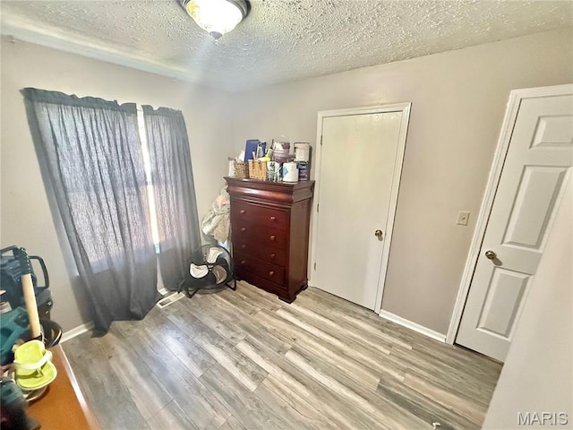 2284 Sunnyridge Dr, Arnold, MO 63010 - bedroom featuring light wood-style floors and a textured ceiling
