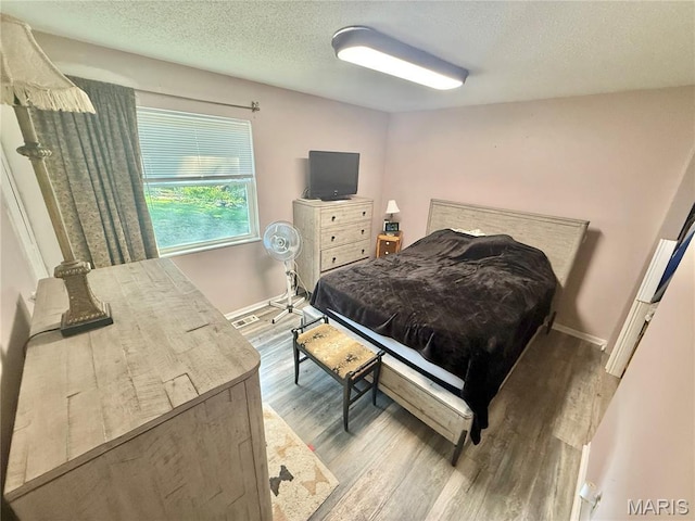 2284 Sunnyridge Dr, Arnold, MO 63010 - bedroom with wood finished floors and a textured ceiling