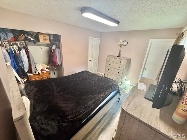 2284 Sunnyridge Dr, Arnold, MO 63010 - bedroom featuring a textured ceiling, wood finished floors, and a closet