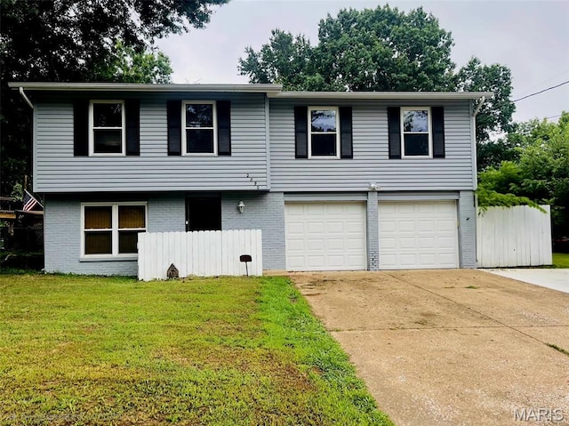 2890 Tommy Dr, Arnold, MO 63010 - view of front of house with an attached garage, concrete driveway, and brick siding
