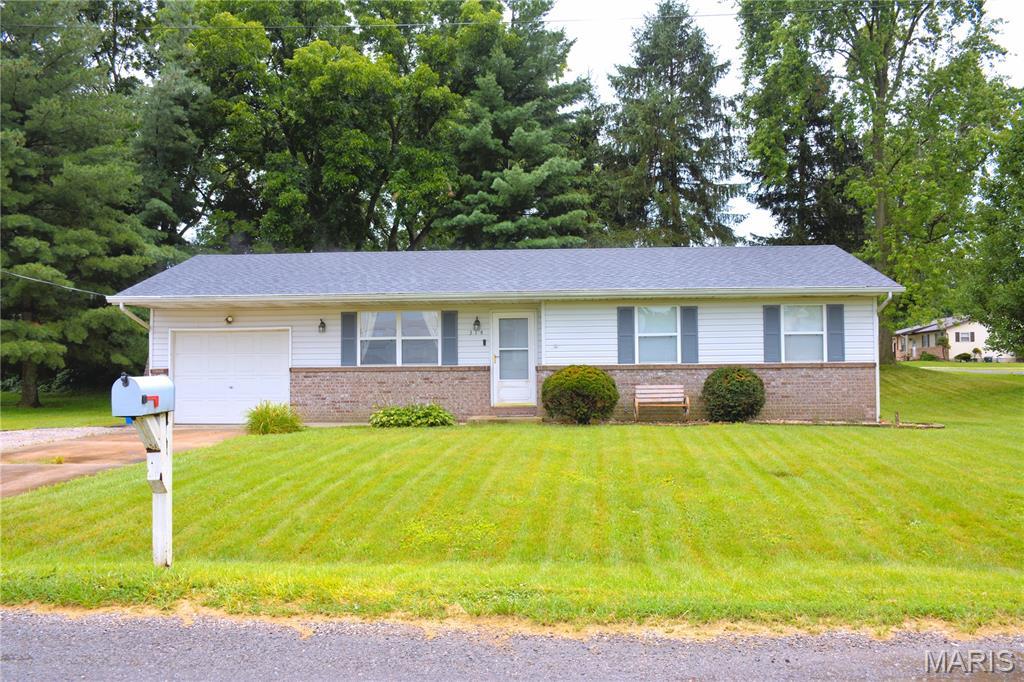 314 Lubeck St, Marine, IL 62061 - ranch-style house with a garage, brick siding, a front lawn, and driveway