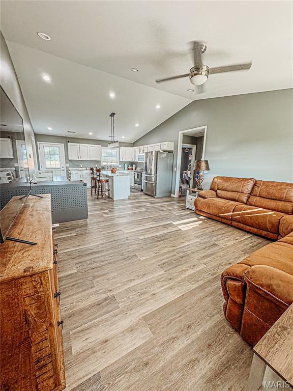 9 Powers Ln, Sikeston, MO 63801 - living room with lofted ceiling, light wood finished floors, a ceiling fan, and recessed lighting