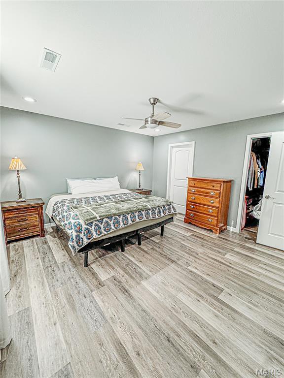 9 Powers Ln, Sikeston, MO 63801 - bedroom with wood finished floors, a ceiling fan, a spacious closet, and recessed lighting