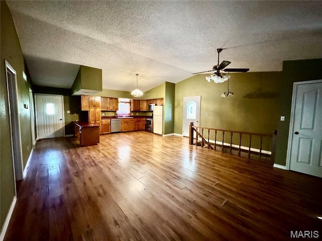 5250 Wren Ln, Osage Beach, MO 65065 - unfurnished living room featuring vaulted ceiling, dark wood finished floors, ceiling fan, a textured ceiling, and a chandelier