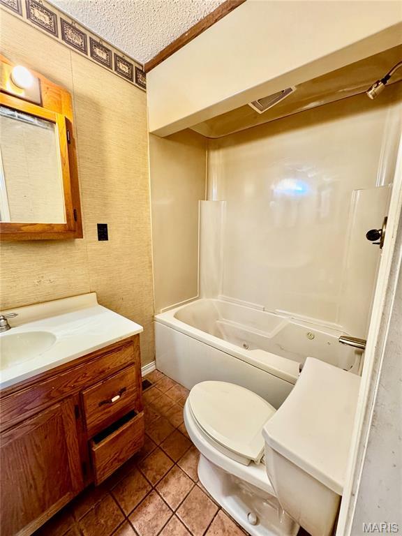 5250 Wren Ln, Osage Beach, MO 65065 - bathroom with vanity, tile patterned floors, a bath, a textured ceiling, and a shower