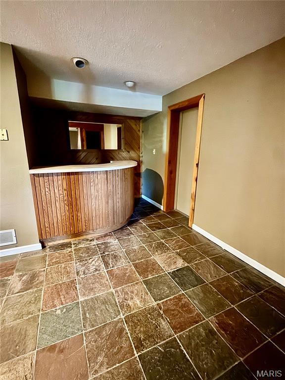 5250 Wren Ln, Osage Beach, MO 65065 - kitchen with a textured ceiling and dark stone finish flooring