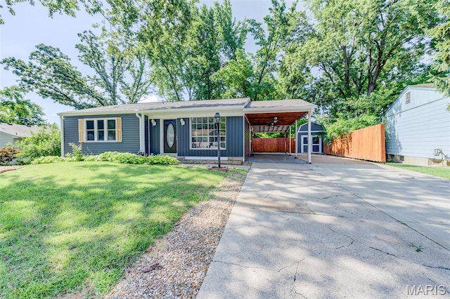 2905 Maldon Ln, Saint Charles, MO 63301 - view of front of property with driveway, a storage shed, a carport, and board and batten siding