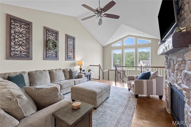 9882 W Vista Dr, Hillsboro, MO 63050 - living area featuring a stone fireplace, a ceiling fan, wood finished floors, and high vaulted ceiling