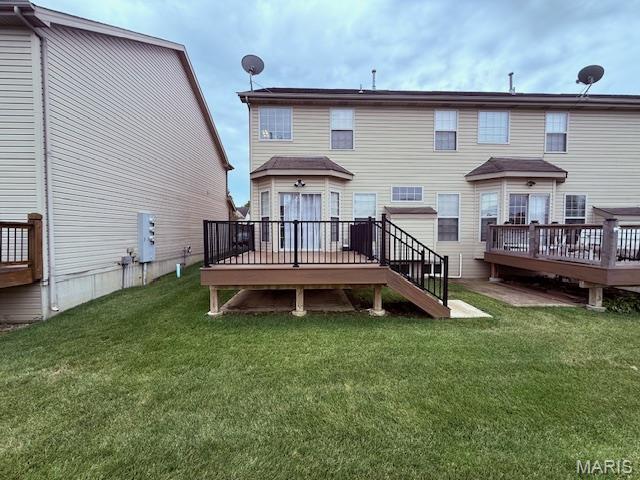 205 Prominence Ln, Lake St Louis, MO 63367 - back of house featuring a wooden deck and a lawn