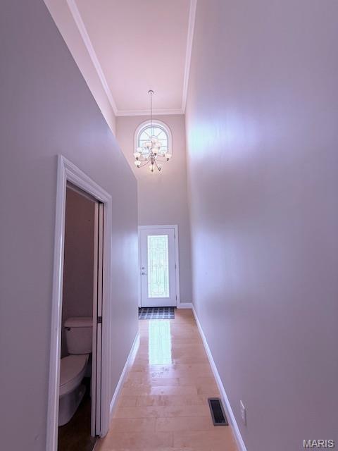 205 Prominence Ln, Lake St Louis, MO 63367 - corridor with a chandelier, crown molding, and a towering ceiling
