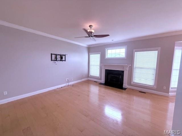 205 Prominence Ln, Lake St Louis, MO 63367 - unfurnished living room featuring crown molding, light wood-type flooring, a fireplace with flush hearth, and ceiling fan