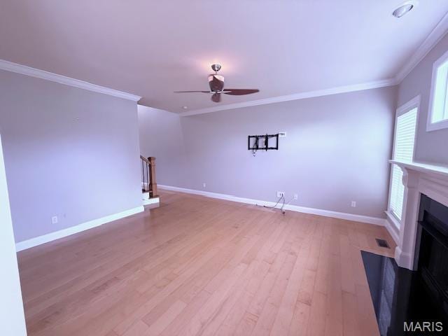 205 Prominence Ln, Lake St Louis, MO 63367 - unfurnished living room featuring a ceiling fan, ornamental molding, light wood-type flooring, and a fireplace with flush hearth