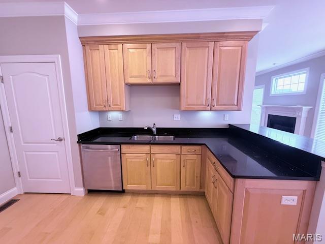 205 Prominence Ln, Lake St Louis, MO 63367 - kitchen with stainless steel dishwasher, light wood-style floors, crown molding, dark countertops, and a peninsula