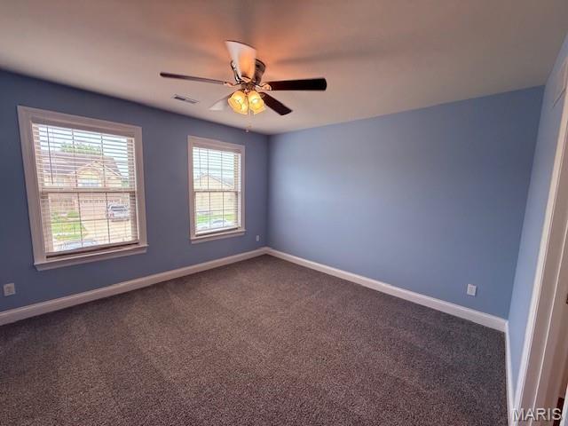 205 Prominence Ln, Lake St Louis, MO 63367 - spare room featuring a ceiling fan and dark carpet
