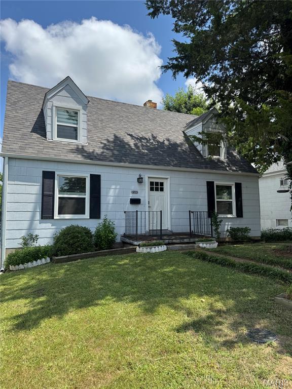 8506 Mathilda Ave, Saint Louis, MO 63123 - new england style home with a front yard and a chimney