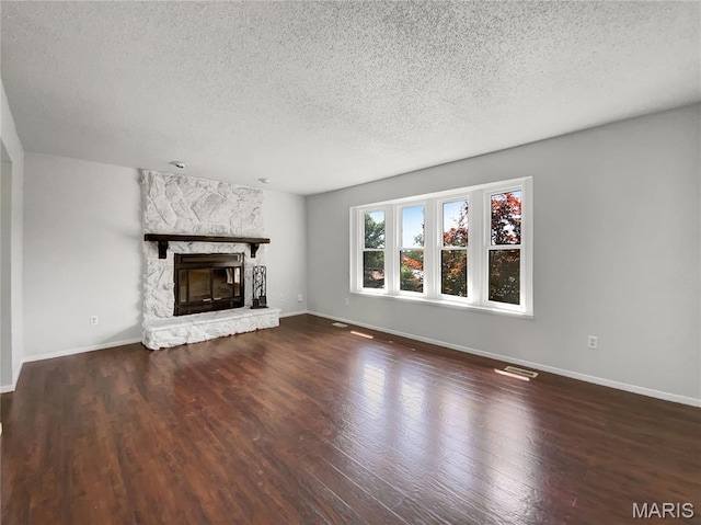 68 W Lakewood Dr, Fenton, MO 63026 - unfurnished living room with a textured ceiling, wood finished floors, and a fireplace
