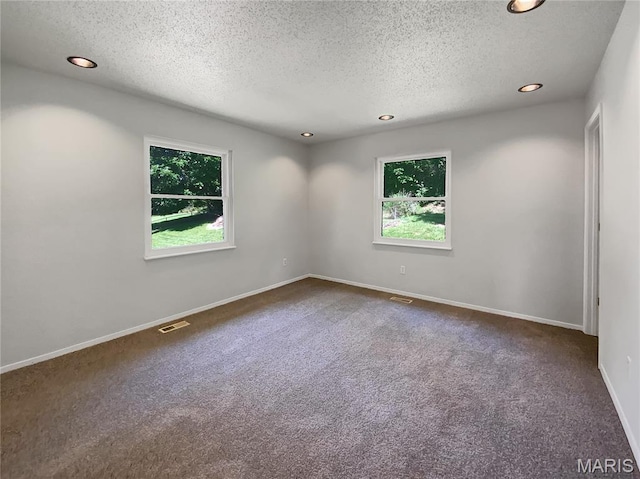 68 W Lakewood Dr, Fenton, MO 63026 - unfurnished room with recessed lighting, dark colored carpet, and a textured ceiling