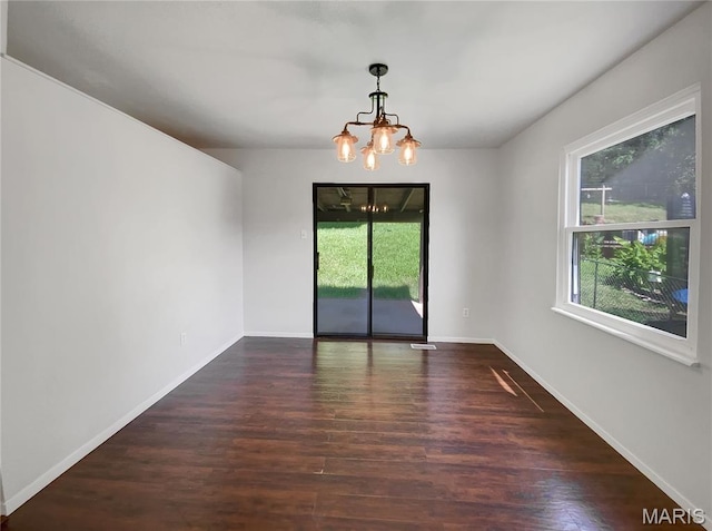 68 W Lakewood Dr, Fenton, MO 63026 - unfurnished room featuring a chandelier, healthy amount of natural light, and wood finished floors