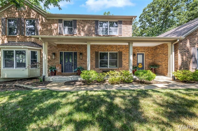 16517 Lancaster Estates Dr, Grover, MO 63040 - traditional-style home with a front yard and brick siding
