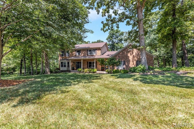 16517 Lancaster Estates Dr, Grover, MO 63040 - view of front of home with brick siding and a front yard