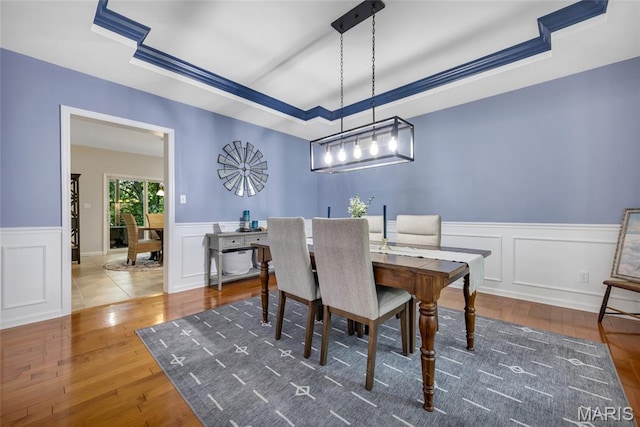 16517 Lancaster Estates Dr, Grover, MO 63040 - dining room with a raised ceiling, wainscoting, wood-type flooring, and a decorative wall
