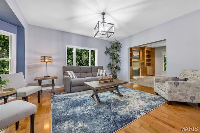 16517 Lancaster Estates Dr, Grover, MO 63040 - living room featuring a chandelier, healthy amount of natural light, and wood finished floors