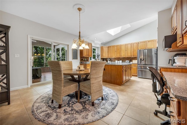 16517 Lancaster Estates Dr, Grover, MO 63040 - dining room featuring a skylight, light tile patterned floors, lofted ceiling, and a chandelier