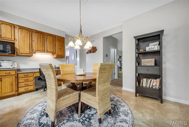 16517 Lancaster Estates Dr, Grover, MO 63040 - dining space featuring light tile patterned floors, a chandelier, and built in desk