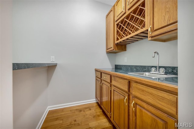 16517 Lancaster Estates Dr, Grover, MO 63040 - bar featuring a sink and light wood-style flooring
