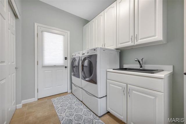 16517 Lancaster Estates Dr, Grover, MO 63040 - washroom with washer and clothes dryer, cabinet space, and light tile patterned flooring