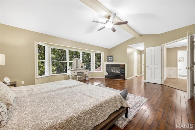 16517 Lancaster Estates Dr, Grover, MO 63040 - bedroom with dark wood finished floors, a glass covered fireplace, wainscoting, a ceiling fan, and a decorative wall