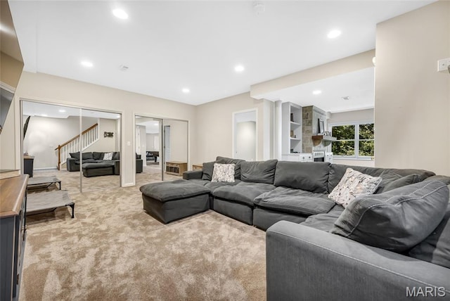 16517 Lancaster Estates Dr, Grover, MO 63040 - living area with stairs, light colored carpet, and recessed lighting