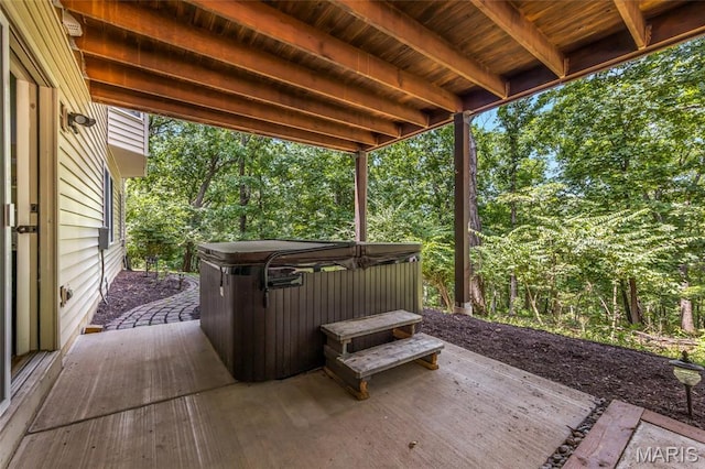 16517 Lancaster Estates Dr, Grover, MO 63040 - wooden deck featuring a hot tub, a patio area, and view of wooded area