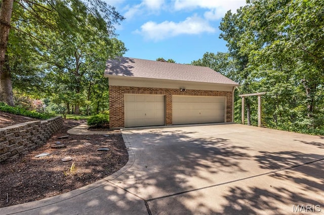 16517 Lancaster Estates Dr, Grover, MO 63040 - view of property exterior with brick siding, concrete driveway, roof with shingles, and a garage