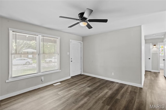 10411 Royal Dr, Saint Louis, MO 63136 - spare room featuring dark wood-style floors, healthy amount of natural light, and ceiling fan