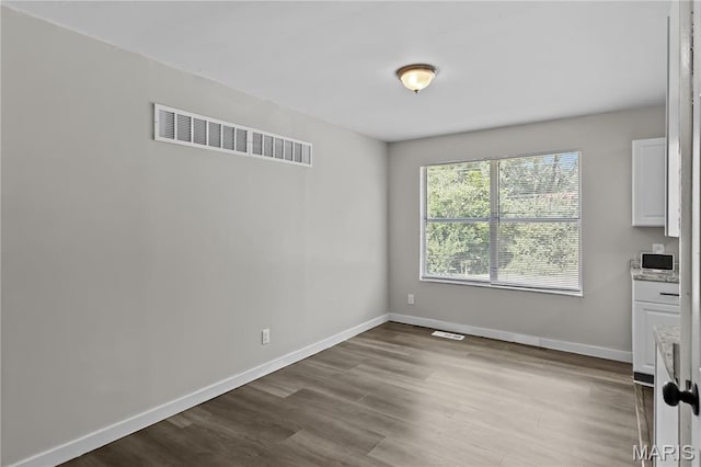 10411 Royal Dr, Saint Louis, MO 63136 - unfurnished dining area featuring wood finished floors and baseboards